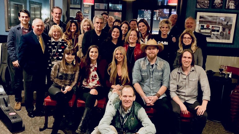 Pictured (L-R) with BMI licensing customers and association partners after the annual CRS BMI songwriter dinner are: (seated) BMI songwriters, Rachele Lynae, Angie K., Julia Cole, Lance Carpenter and Jimmy Nash (front): BMI’s Dan Spears.