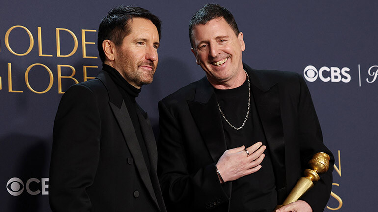 BMI composer Atticus Ross accepts the Golden Globe award for Best Original Score – Motion Picture alongside collaborator Trent Reznor.